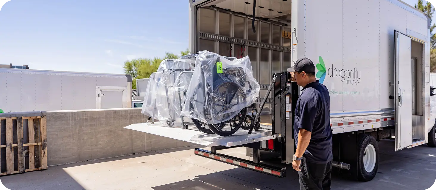 DME technician loading medical equipment for home delivery